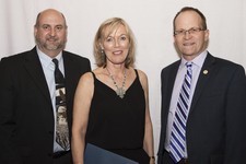 Superintendent Dr. Troy Davies (right) and St. Augustine School Principal Kevin Prediger honour Mary Desaulniers (St. Augustine School) on her retirement.