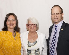 Superintendent Dr. Troy Davies (right) and Holy Trinity Vice Principal Keri-Lynn Clark (left) honour Michelle Andre (Holy Trinity Academy) on her retirement.  