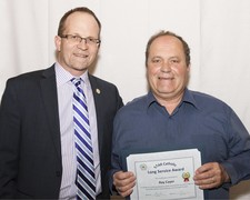 Superintendent Dr. Troy Davies honours 35 Year Long Service honouree Ray Cayer.